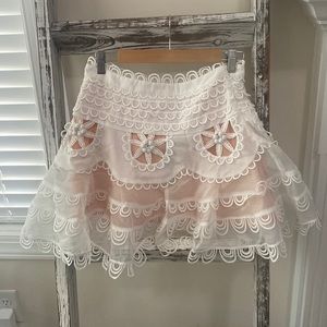 Brand New! White eyelet detailed skirt w/ tags. Size L